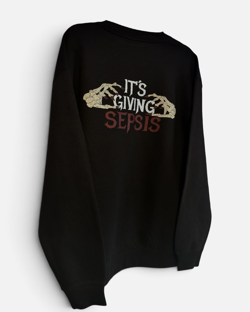 It's Giving Sepsis oversized crewneck laid flat, full back print on black heavyweight fleece