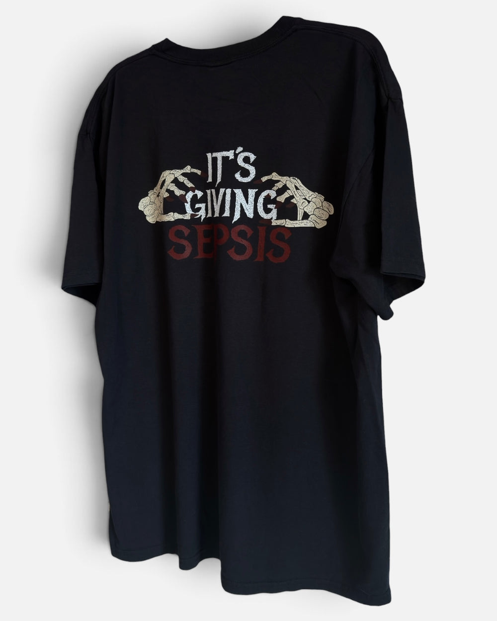 It's Giving Sepsis black nurse tee, back print with skeleton hands gripping the words