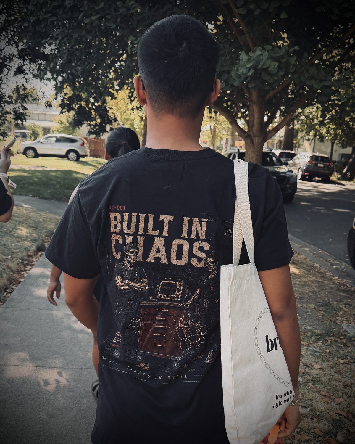 RX-001 Built in Chaos tee worn on a walk, back print visible