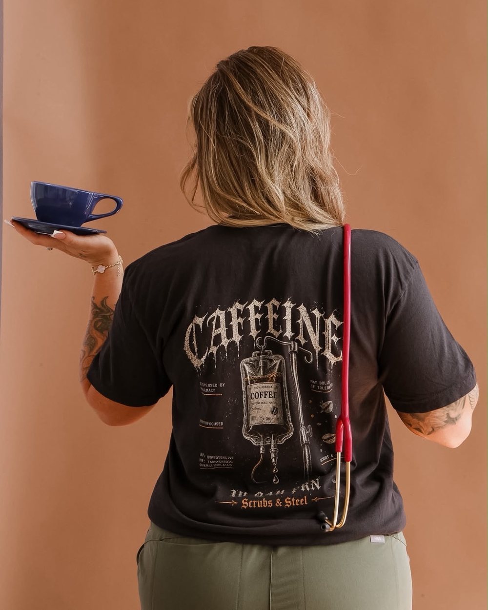 Black tee with a back print, shown from behind
